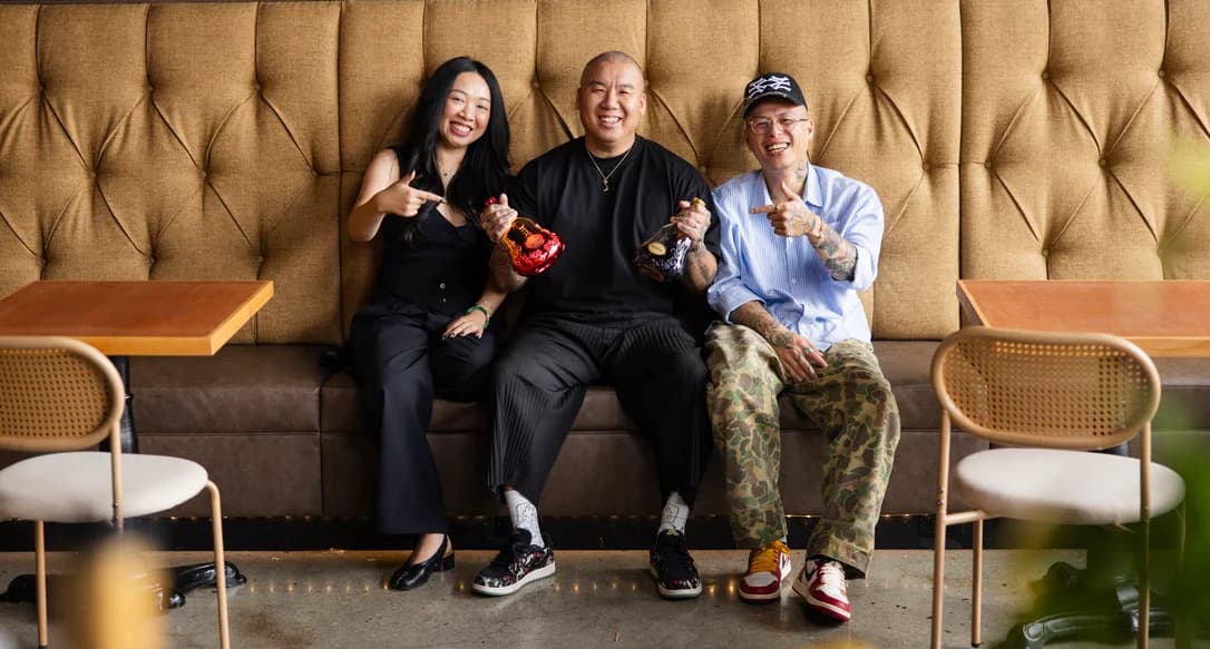 The three founders of After Ours, laughing on a tufted banquette.